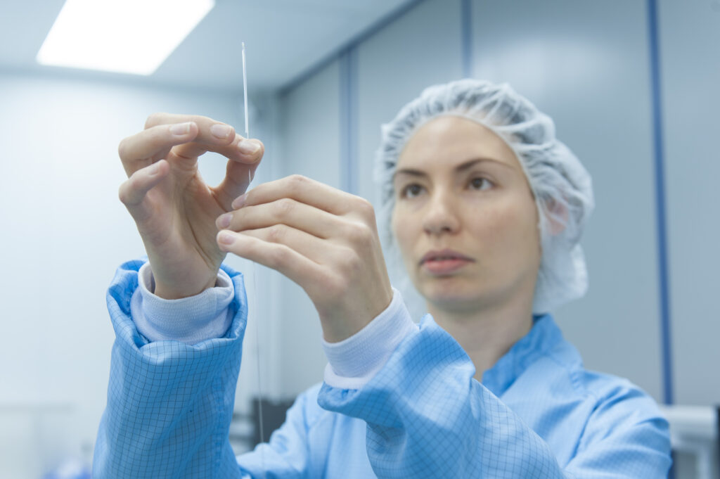 R&D engineer holding and examining product